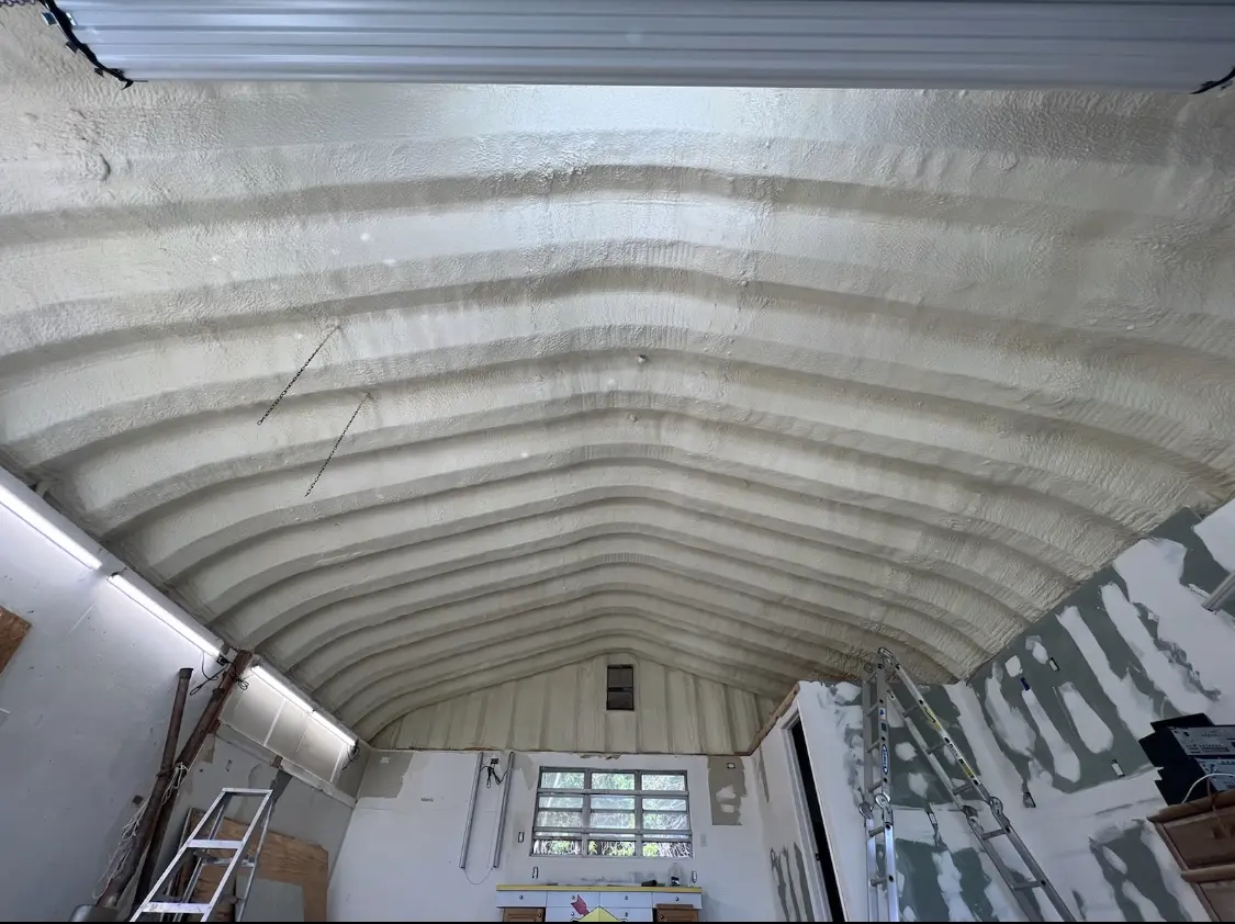 Spray polyurethane foam applied to the underside of a metal roof deck in Hoosick